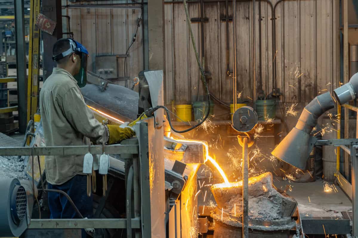 A Worker Is Working On A Metal Object In Badger Foundry.