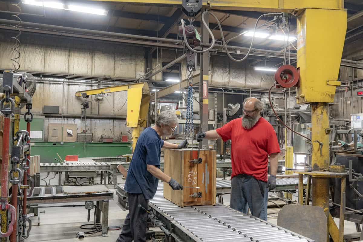 Two Men Working In Badger Foundry On Assembly Line