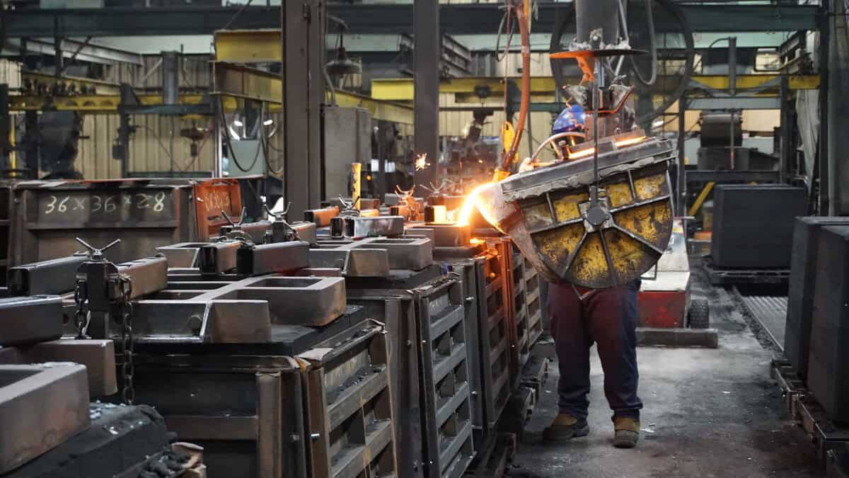 Badger Foundry Employee Pouring Melted Metal Into A Mold.