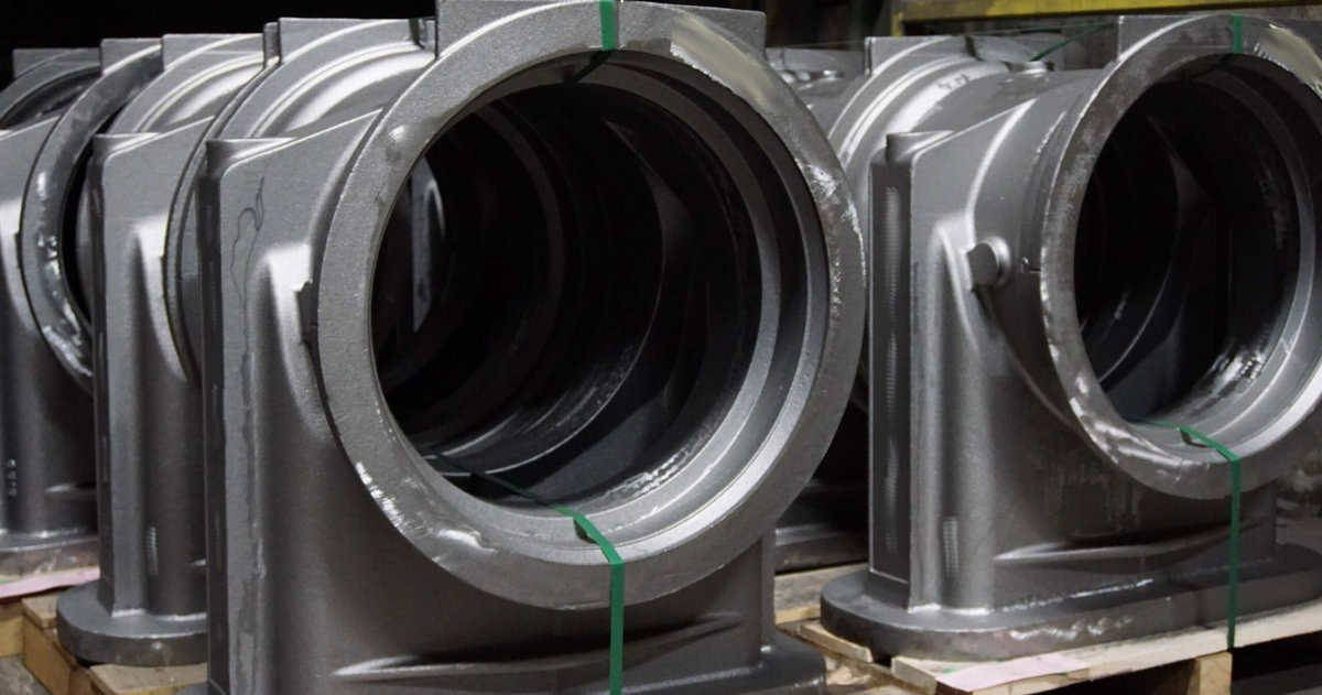 Several Large Metal Pipes Are Stacked On Pallets.