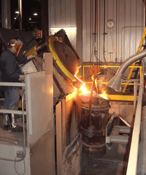 One Badger Foundry Employee Is Pouring Molten Metal Into Something