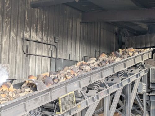A Conveyor Belt With Rocks On It