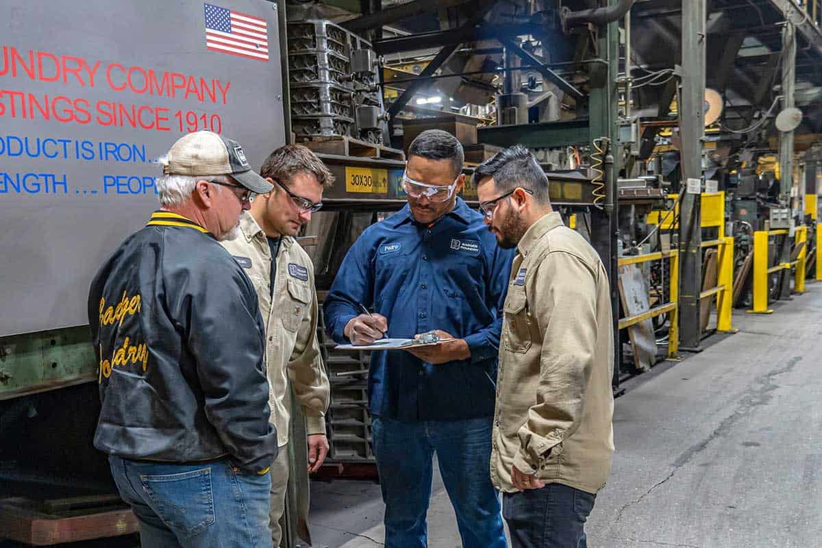 4 Badger Foundry Employees Discussing Continuous Improvement